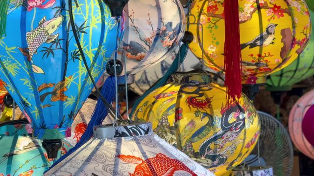 Colorful traditional lanterns displayed at local market in Hoi An, Vietnam. Decorative silk lanterns with detailed patterns represent Asian culture, craftsmanship, and everyday life in Southeast Asia.