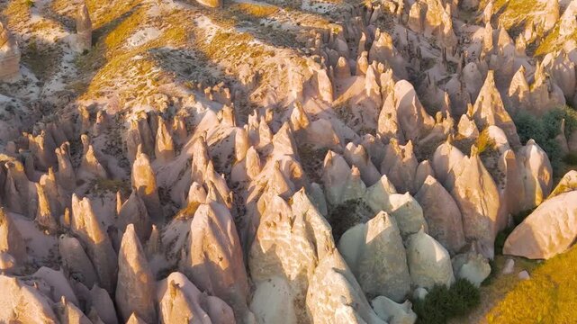 Goreme, Nevsehir, Turkey. Premium aerial footage of Devrent Valley featuring extraordinary rock shapes and sunset color palette.. Aerial View, MasterShots, Circle (Close)