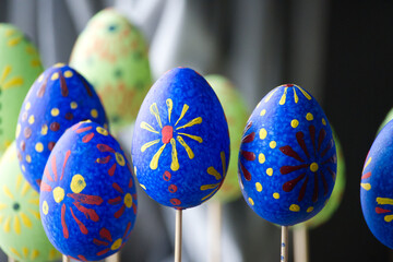 Close-up shot of colorful Easter eggs on sticks, representing the holiday season.