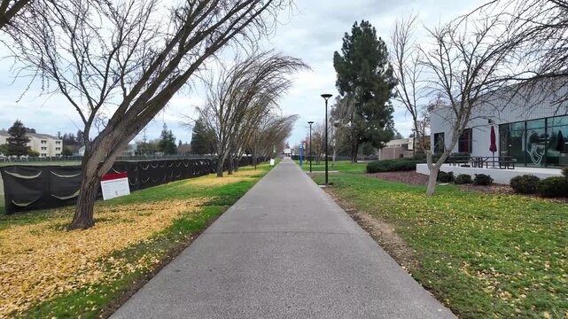 This pedestrian tour of Stanislaus State focuses on campus textures and layout, from concrete paths to grassy lawns, capturing the everyday pace of student life.