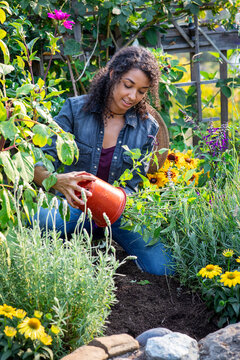 Young woman planting in her garden