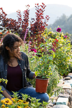 Woman working in her beautiful backyard garden 