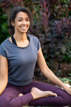 Young woman doing yoga and meditating outdoors