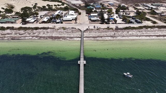Fowlers Bay jetty, South Australia &ndash; 4K aerial drone view of Great Australian Bight coastline, caravan park, turquoise ocean, sand dunes, white sand beach and limestone cliffs