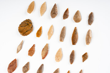Obraz premium Collection of Rare Paleolithic Bifacial Stone Arrowheads from Algerian Sahara Desert on White Background 