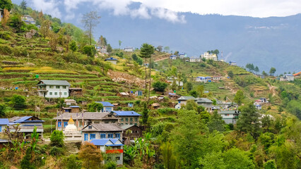 A colorful Himalayan village built on steep terraced mountain slopes