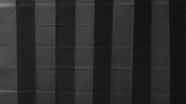 Folded Black Paper with Vertical Accordion Pleats abstract