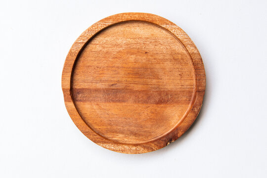 Round wooden coaster isolated on white background. Top view