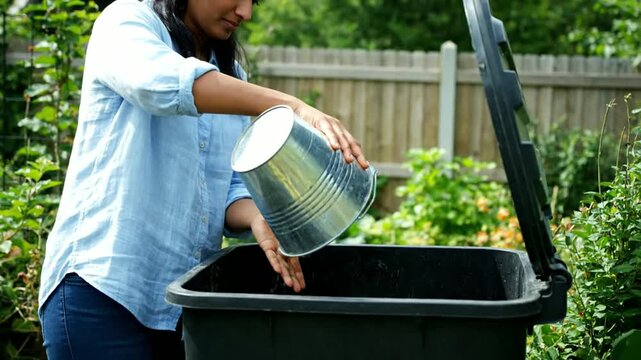Woman Composting Organic Waste in Garden.