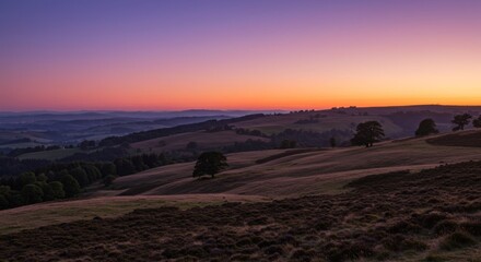 Fototapeta premium Vibrant Sunset Over Rolling Hills and Fields