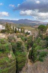 Obraz premium ronda,malaga,spain Looking down at el tajo gorge and the guadalevin river with buildings of ronda town perched dramatically on the cliffs