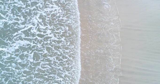 A top down view of the beautiful and mesmerizing texture of sea foam during a golden sunset