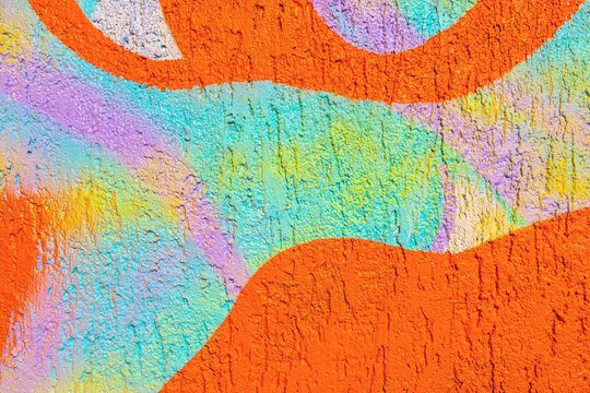 Abstract geometric mural in bright orange, turquoise, lavender with 90s pastel, funky style, textured wall. Urban art, street decor, background, creative banner, modern 90s, 2000s, y2k visuals.