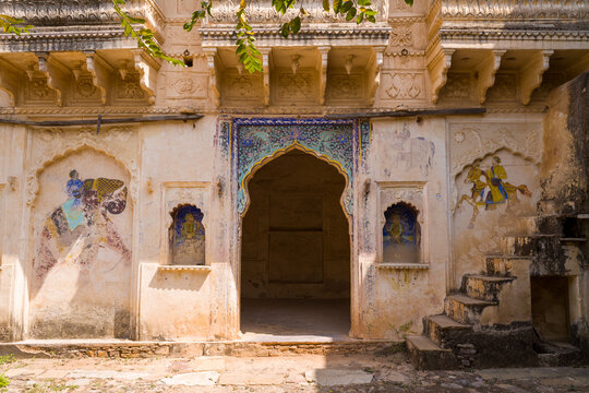 Bundi, India - March 20, 2022: The image shows a decorated entrance gate at Taragarh Fort with intricate architectural details and faded wall paintings depicting figures on an elephant and a horse