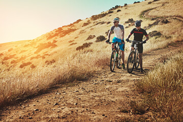 Fototapeta premium Friends, cycling and people on bicycle, countryside and training for sport competition and together. Outdoor, sunshine and athlete on bike for cardio, fitness and race challenge in nature or space