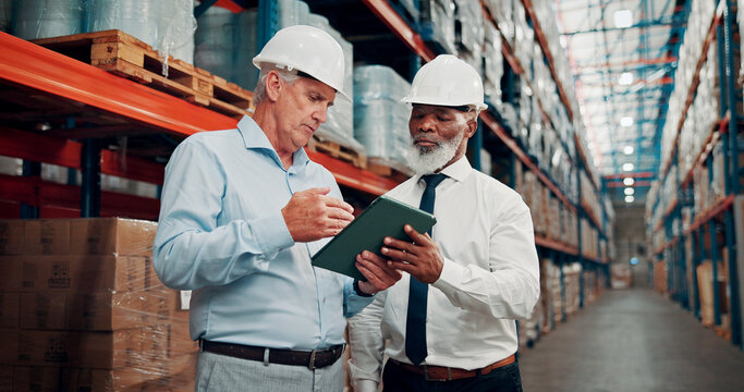 Tablet, men and supply chain managers in warehouse with information for online order with shipping. Teamwork, digital technology and male logistics employees with confirmation for quality control.