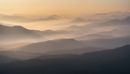 Misty mountain ridge dawn mist sunrise valley fog layered hills pastel sky tranquil