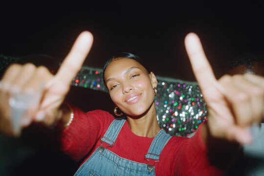 Young woman dancing at party feeling joy and fun