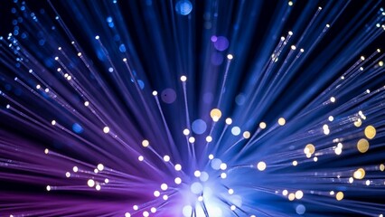 Vibrant fiber optic cables with glowing purple and blue lights radiating from center creating dynamic abstract background with multiple light streaks and bokeh effects