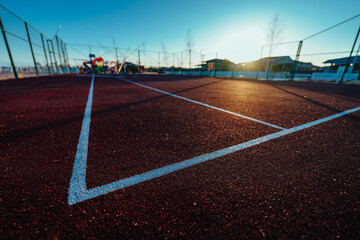 Edge of basketball court markings with perspective view at sunrise