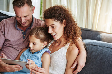 Obraz premium Happy, sofa and parents with child on tablet for bonding, watching videos, website and cartoons in home. Family, relax and mom, dad and girl on digital tech for streaming, connection and weekend