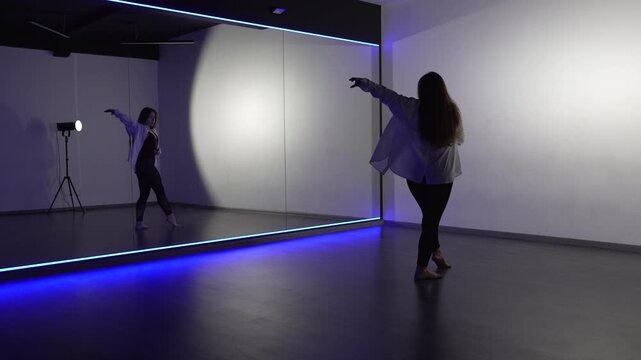 Dancer studio choreography young woman practicing contemporary routine performing dramatic modern movements by a mirror