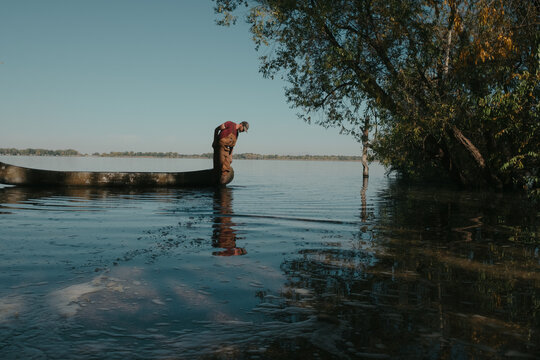 Fisherman standing in canoe on summer lake oregon