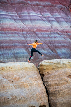Action shot of woman jumping in Paria Mountains