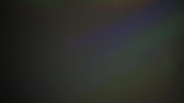 Colorful abstract cd light patterns shifting and blurring in dark ambient background