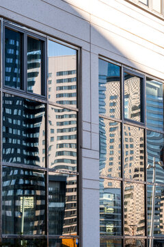 Abstract modern skyscraper architecture facade with glass reflection and urban windows forming geometry and clean lines for corporate city background