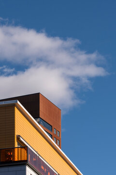 Modern minimal architecture building corner against sky with bold color contrast highlighting urban lines and clean geometric shapes in sunlight