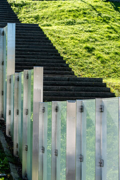Modern minimal architecture staircase beside grass and concrete showing urban pattern texture and strong lines in clean geometric outdoor composition