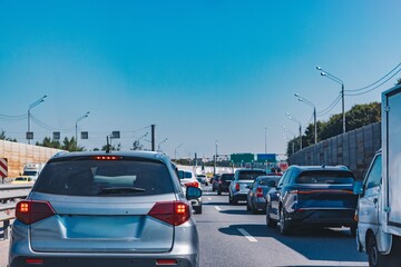 Traffic Jam on a Sunny Day: Cars Stuck on a Busy Highway with Clear Blue Skies Above