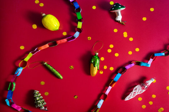 Christmas tree decorations and paper chain on red festive background
