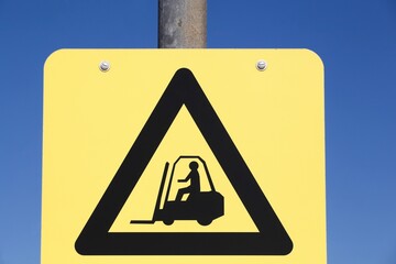 Caution forklift traffic sign on a pole