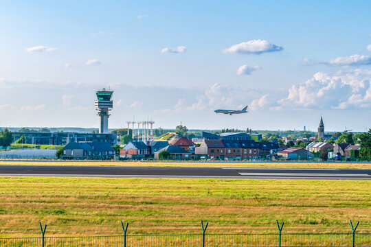 Brussels, Belgium - July 21 2023: AeroLogic cargo airplane on final approach for landing at Brussels Airport with control tower background