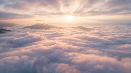 Obraz premium Sunrise over mountains and clouds with soft light and mist in the sky