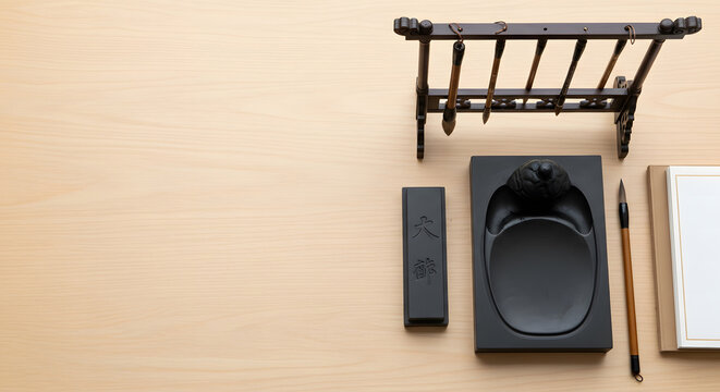 Traditional East Asian Calligraphy Tools Set on Light Wood Desk