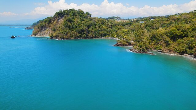 Turquoise coastal waters meet lush cliffs and hidden beaches in Costa Rica.