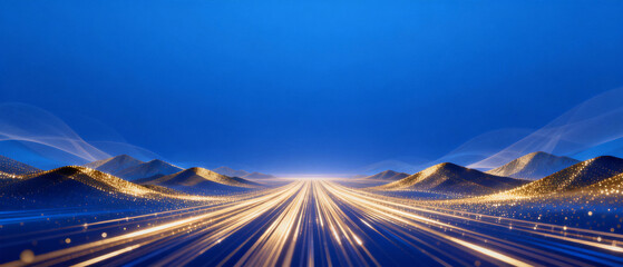 Nighttime highway with light trails stretching into the distance, framed by illuminated mountains under a deep blue sky