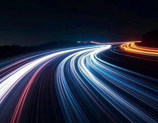 Long-exposure shot showing blurred car headlights on a curving highway at night