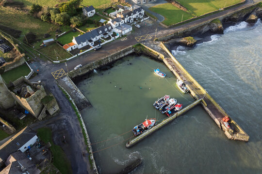 Aerial view of Slade Harbour with historic Slade Castle, fishing boats and winter light on Ireland&rsquo;s Hook Peninsula
