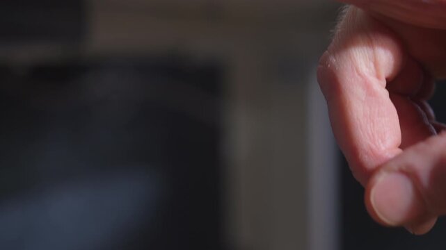 Finger pressing button to raise adjustable standing desk