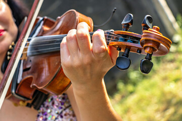 A woman playing a violin in a park. © Констянтин Батыльчук