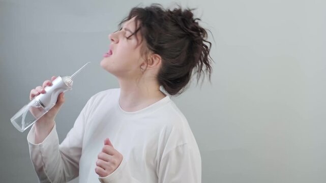 Dancing singing and clean teeth with a water flosser. A fun morning starts with self care and a cheerful positive mood.