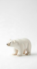 Fototapeta premium Polar Bear Figurine on White Background - A Study in Simplicity.