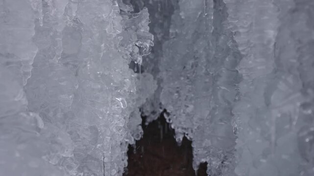 In the cold winter, the river freezes and the long ice hangs dripping with water