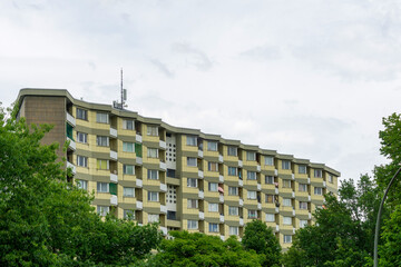 Modernist Residential Apartment Block in Siemensstadt Berlin with Serrated Zig Zag Facade and Yellow Tiled Panels surrounded by Lush Green Trees