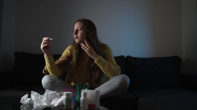 Female experiencing flu symptoms and weakness at home. Winter illness, healthcare, immunity, and recovery concept.