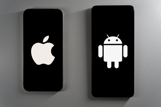 Two smartphones at an angle displaying Apple and Android logos on black screens.